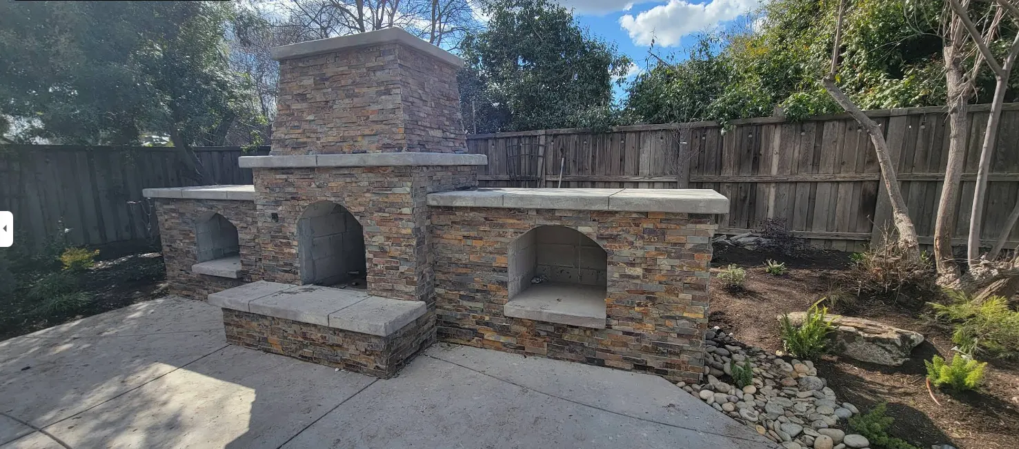 Outdoor stone fireplace built as part of home remodeling in Fresno CA, showcasing professional remodeling services that provide more space and a full range of design options.